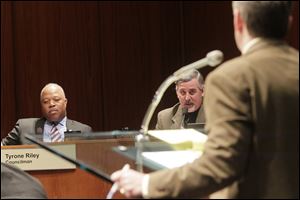 Council member Tyrone Riley, left, listens as council member Steven Steel, center, responds to attorney Jeffrey Zilba, right, Tuesday afternoon during the Toledo City Council's meeting of the Public Safety, Law and Criminal Justice Committee at the council chambers in downtown Toledo.