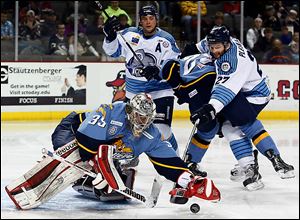 Walleye goalie Kent Simpson blocks a shot by Evansville’s Adam Pleskach during the second period on Wednesday. Simpson made 26 saves and recorded his second straight shutout, helping the Walleye earn two critical points with five regular season games remaining before the playoffs begin.