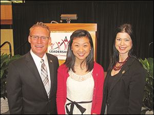 Bill Garbe, Connect for Leadership event chairman, left, with student speaker Jenny Kim, center, and Carrie Serber, board chairman.
