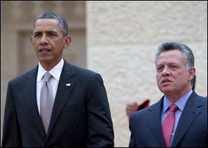 President Barack Obama walks with Jordan's King Abdullah II to participate in an official arrival ceremony at Al-Hummar Palace, the residence of Jordanian King Abdullah II, in Amman, Jordan.