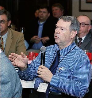 Gordon Bowman of Pemberville addresses a question to speaker Rick Hodges, executive director of the Ohio Turnpike, during a summit at the Holiday Inn French Quarter in Perrysburg Township.