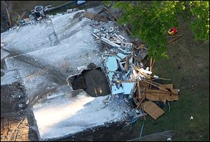 A giant sinkhole is shown at the site of Jeff Bush’s home in Seffner, Fla.  The sinkhole opened up under a bedroom in the home on Feb. 28  and swallowed  Mr.  Bush, 37. Officials eventually gave up hope of finding him alive and filled in the hole with crushed rock.  The house was razed.