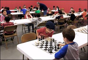Timothy Atkinson, 6, of Bowling Green, left, and Calvin Mlcek, 7, of Monclova play in the K-2 section during the 2013 Great Lakes Chess Association Scholastic Open chess tournament.