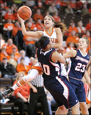 BG’s Jillian Halfhill (11) is fouled by Duquesne’s Wumi Agunbiade (10) during the first half of their WNIT game at the Stroh Center.