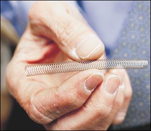 Dr. Mark Burket, UTMC chief cardiologist, holds the Zilver stent for patients with peripheral artery disease.