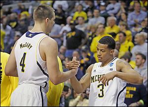 Michigan’s Mitch McGary, left, celebrates with guard Trey Burke after their 78-53 win over Virginia Commonwealth on Saturday.