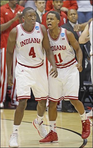 Indiana guard Victor Oladipo, left, and guard Yogi Ferrell celebrate after they defeated Temple 58-52 in a third-round game of the NCAA tournament Sunday in Dayton. Four Big Ten schools are still alive in the Sweet 16.