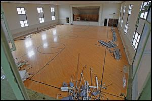 The armory's gymnasium floor is one item that could not be salvaged and will end up in a landfill. It has too many nails and was breaking apart.