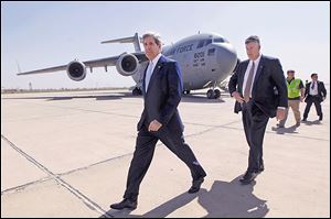 U.S. Secretary of State John Kerry, left, arrives in Baghdad to meet with Iraq’s Prime Minister Nouri al-Maliki. Mr. Kerry’s Sunday visit was unannounced.