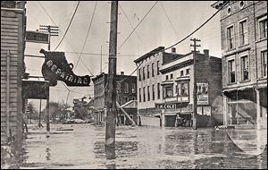 Nineteen people died in Tiffin from the overflowing Sandusky River, which flooded Washington Street, above. The storm started with hurricane-force winds on Good Friday, and the rain started to fall. Because weather predictions were not as sophisticated a century ago, many people decided to wait out the storm.