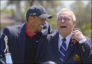Tiger Woods, left, and Arnold Palmer share a laugh during the trophy presentation after Woods won the Arnold Palmer Invitational for the eighth time.