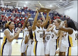 Jayda Worthy holds up the Division I regional championship trophy after Notre Dame defeated Wadsworth. The Eagles (25-4), who lost in the state semifinals, won the Three Rivers Athletic Conference title.