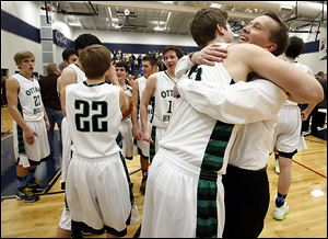 Lucas Janowicz hugs Ottawa Hills coach John Lindsay after defeating Toledo Christian in the Division IV district final.