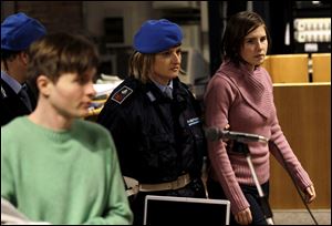 Amanda Knox, right, walks past Raffaele Sollecito, as she arrives after a break to attend a hearing in her appeals trial, at Perugia's courthouse, Italy, in December, 2010.