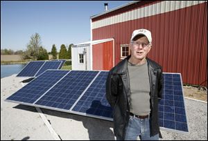 Dan Kronfield with his solar power generating equipment at his home on Five Points Road.