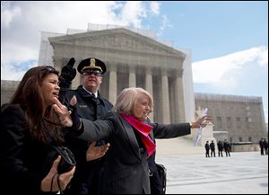 Edith Windsor of New York, arms outstretched, greets a sea of supporters outside the Supreme Court, which heard arguments on the Defense of Marriage Act.