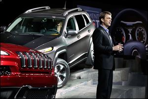 Mike Manley, chief executive for the Jeep brand, presents the 2014 Jeep Cherokee Limited, left, and Cherokee Trailhawk at the New York International Auto Show at the Javits Center.