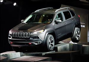 The 2014 Jeep Cherokee Trailhawk drives over obstacles as it is introduced Wednesday at the New York International Auto Show.