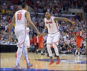 Ohio State's LaQuinton Ross, left, and Deshaun Thomas celebrate after Ross’ late 3-pointer sealed a dramatic win against Arizona.