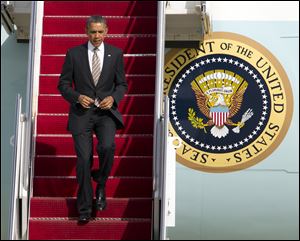 President Barack Obama walks down the stairs from Air Force One upon arrival at Andrews Air Force Base, Md.