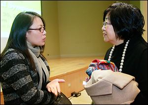 Qiuying Zhao, left, speaks with Margaret Wong, an immigration attorney and civic leader from Cleveland during the Women of the World Symposium.