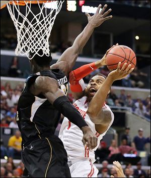 Wichita State center Ehimen Orukpe defends Ohio State forward Deshaun Thomas in the first half when the Buckeyes shot just 24 percent. OSU fell behind by 20 points in the second half before staging a furious rally that fell short. Ohio State finishes 29-8.