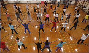 More than 50 teachers, students, school volunteers, and neighbors near Scott High School fill the gym in Angela Steward's Fabulously Fit class.