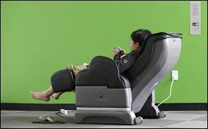 Google software engineer Jiang Chen campus sits in a massage chair at a Google campus building in Mountain View, Calif. Companies say extraordinary campuses are a necessity, to recruit and retain top talent, and to spark innovation and creativity in the workplace. And there are business benefits and financial results for companies that keep their workers happy.