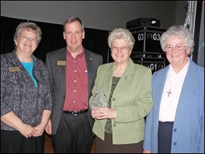 William Balzar, left center, stands with, from left, Sister Mary Ann Culpert, Sister Mary Delores Gatliff , and Sister Mary Carol Gregory, of Notre Dame Academy, as they accepted the Diamond Eagle Award.