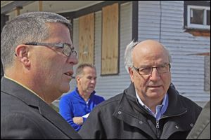 Rev. Dan Rogers, President & CEO of Cherry Street Mission Ministries, left, and Pastor Keith Sholl, senior pastor at Toledo First Alliance Church, right. Behind them, center is Jim Moline, the volunteer general contractor from Moline Builders, Inc. 