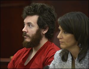 James Holmes, left, and defense attorney Tamara Brady appear in district court in Centennial, Colo. for his arraignment on March 13.