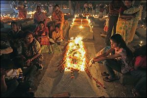 Indian Christians light candles and pray beside the graves of their dear ones in the early morning as they observe Easter in Purulia, about 220 miles west of Kolkata, India.