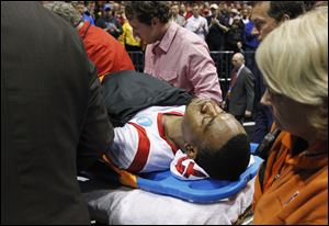 Louisville guard Kevin Ware is taken off of the court  on a stretcher after his injury during the first half of the Midwest Regional final against Duke.