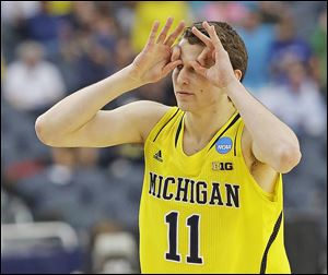 Michigan's Nik Stauskas reacts after making a 3-pointer shot during the first half of a regional final game against Florida. Stauskas hit all six of his 3-pointers and finished with 22 points.