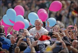 Pope Francis passes among the crowd after celebrating his first Easter Mass in St. Peter's Square at the Vatican on Sunday.  The Roman Catholic leader called for ‘peace in all the world,’ then aimed his Easter greetings at ‘every house and every family, especially where the suffering is greatest, in hospitals, in prisons.’