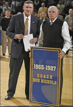 Mike O’Brien, University of Toledo athletics director, left, and Bob Nichols watch as a banner is raised in honor of the former coach at Savage hall in 2008.