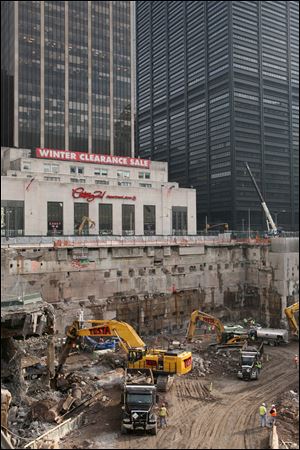 Construction workers and equipment excavate the southeastern corner of the World Trade Center site.
