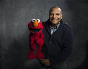 Former Elmo and puppeteer Kevin Clash with the famous Muppet.