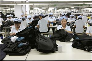 North Korean workers assemble Western-style suits at the South Korean-run ShinWon Corp. garment factory inside the Kaesong industrial complex in Kaesong, North Korea, in September, 2012.