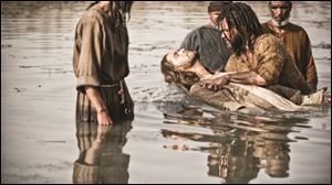 John played by Daniel Percival, right, baptises Jesus played by Diogo Morgaldo in a scene from the 5-part miniseries 'The Bible.'