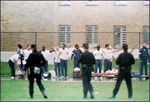 Inmates raise their hands in surrender during a riot at the Southern Ohio Correctional Facility in Lucasville. The 1993 siege lasted 11 days. 