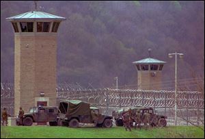 Law officers and National Guard troops assemble outside the Southern Ohio Correctional Facilty April, 1993 as a riot by inmates enters its 10th day.