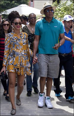 U.S. singer Beyonce and her husband, rapper Jay-Z, hold hands Thursday as they tour Old Havana, Cuba.
