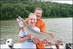 Jenna Lederer and her father, Fred Lederer, pose with a 42-inch muskie she caught in July.