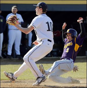 Maumee's Tommy Henry scores on a wild pitch thrown by St. John's pitcher Jacek Czerwinski, left during the third inning of Wednesday’s game. Henry also drove in a run for the Panthers.