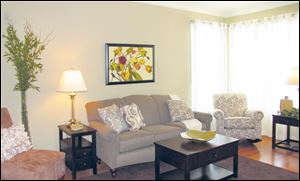 Corner windows make this comfortable living room light and bright. 