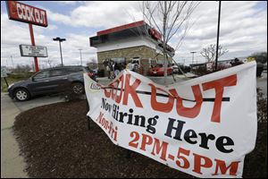This  Friday, March 29, 2013, photo, shows a help wanted sign in front of a restaurant in Richmond, Va.  The U.S. economy has enjoyed a four-month stretch of robust job gains, and on Friday, April 5, 2013, the government will signal whether that trend endured into March.
