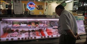 A customer shops for seafood at Monahan's Seafood in Ann Arbor, Mich.