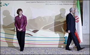 EU foreign policy chief Catherine Ashton, left, smiles, as Secretary of Iran’s Supreme National Security Council Saeed Jalili walks away, after a photo call at a start of high-level talks between world powers and Iranian officials in Almaty, Kazakhstan on Friday, April 5, 2013. (AP Photo/Shamil Zhumatov, Pool)