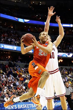 Syracuse guard Brandon Triche shoots past Indiana forward Cody Zeller during a Sweet 16 game on March 28. Triche claimed the Orange have mismatch advantages over Michigan at every position.